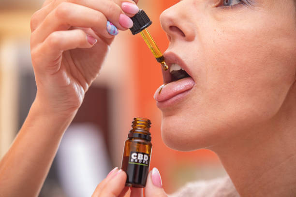 Adult Woman Taking CBD Cannabis Oil.