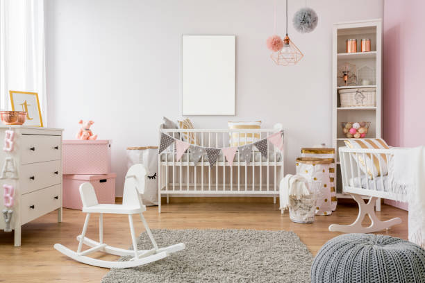 White poster mockup over crib in pastel baby room